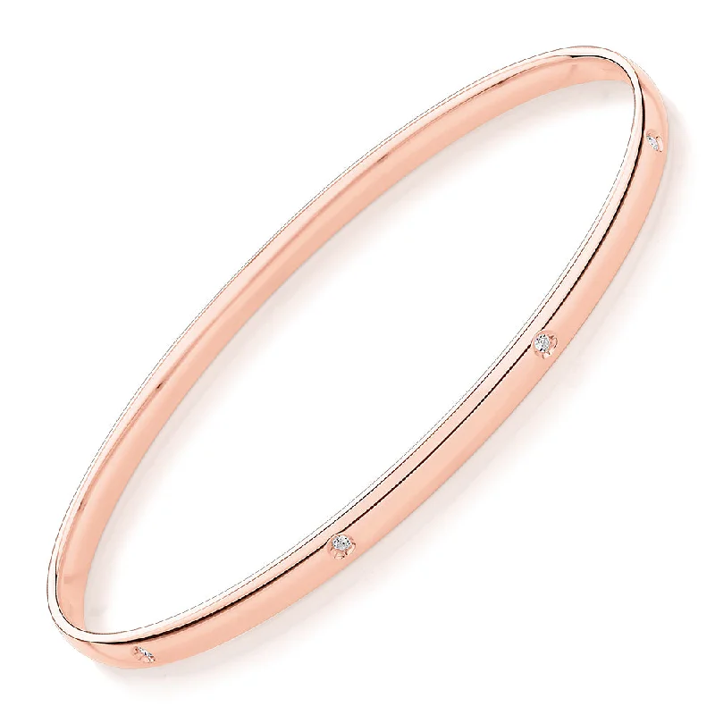 Fashionable Gold Bangles-Oval bangle with diamond simulants in 10 carat rose gold